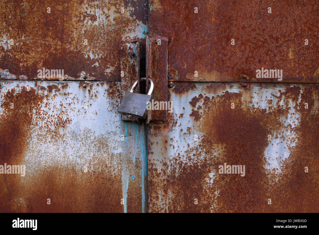 Stained metal portal with padlock (France Stock Photo Alamy