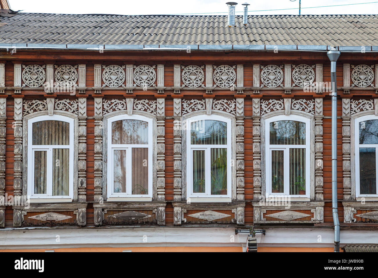 Wall of wooden traditional russian house with windows and carved frames and pattern Stock Photo