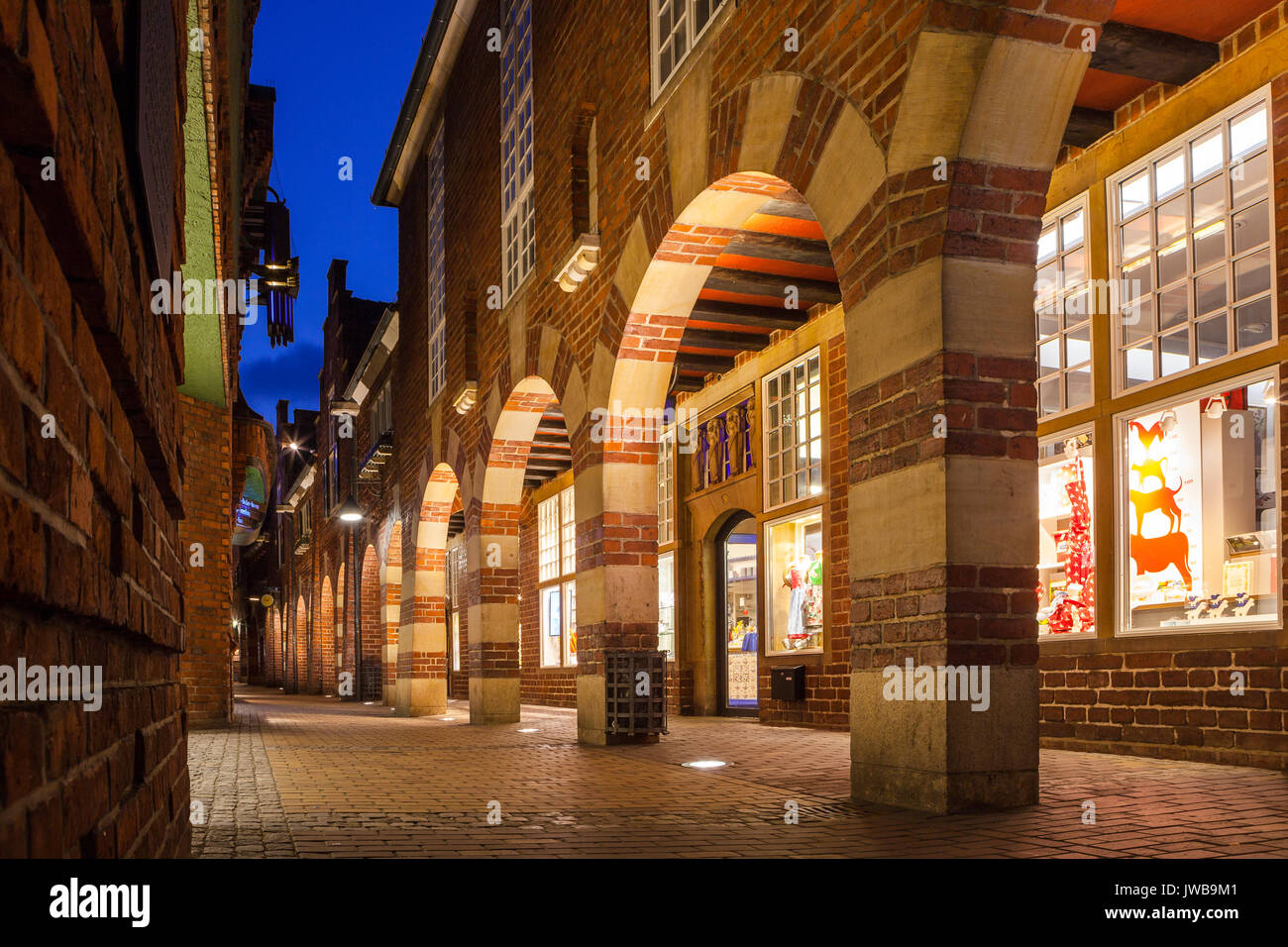BREMEN, GERMANY - 16 APR 2016: Boettcherstreet by night in Bremen. Only about 100 m long, it is famous for its unusual architecture and ranks among the citys main cultural landmarks. Stock Photo