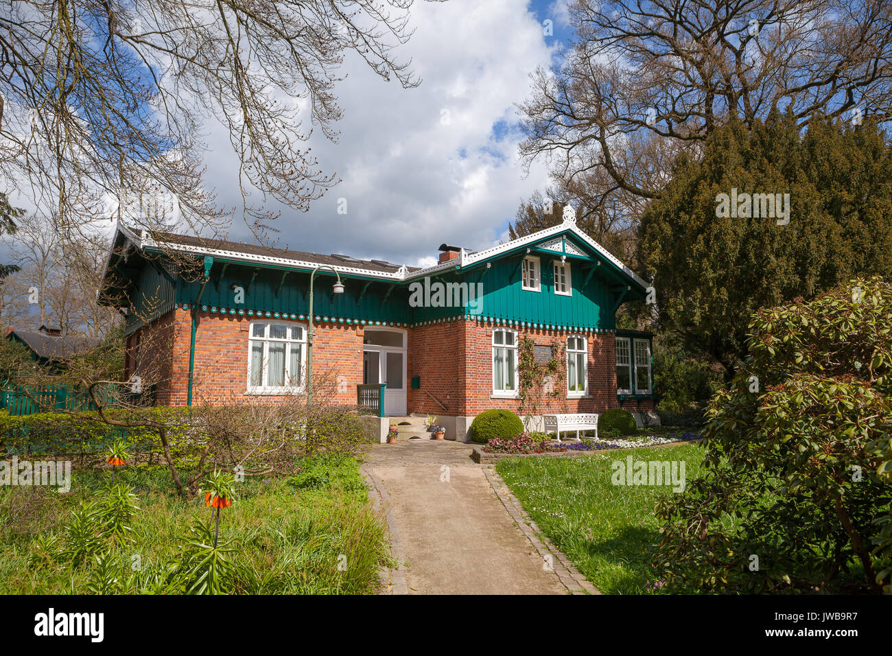 Old style brick house with wooden roof in green parl Stock Photo Alamy