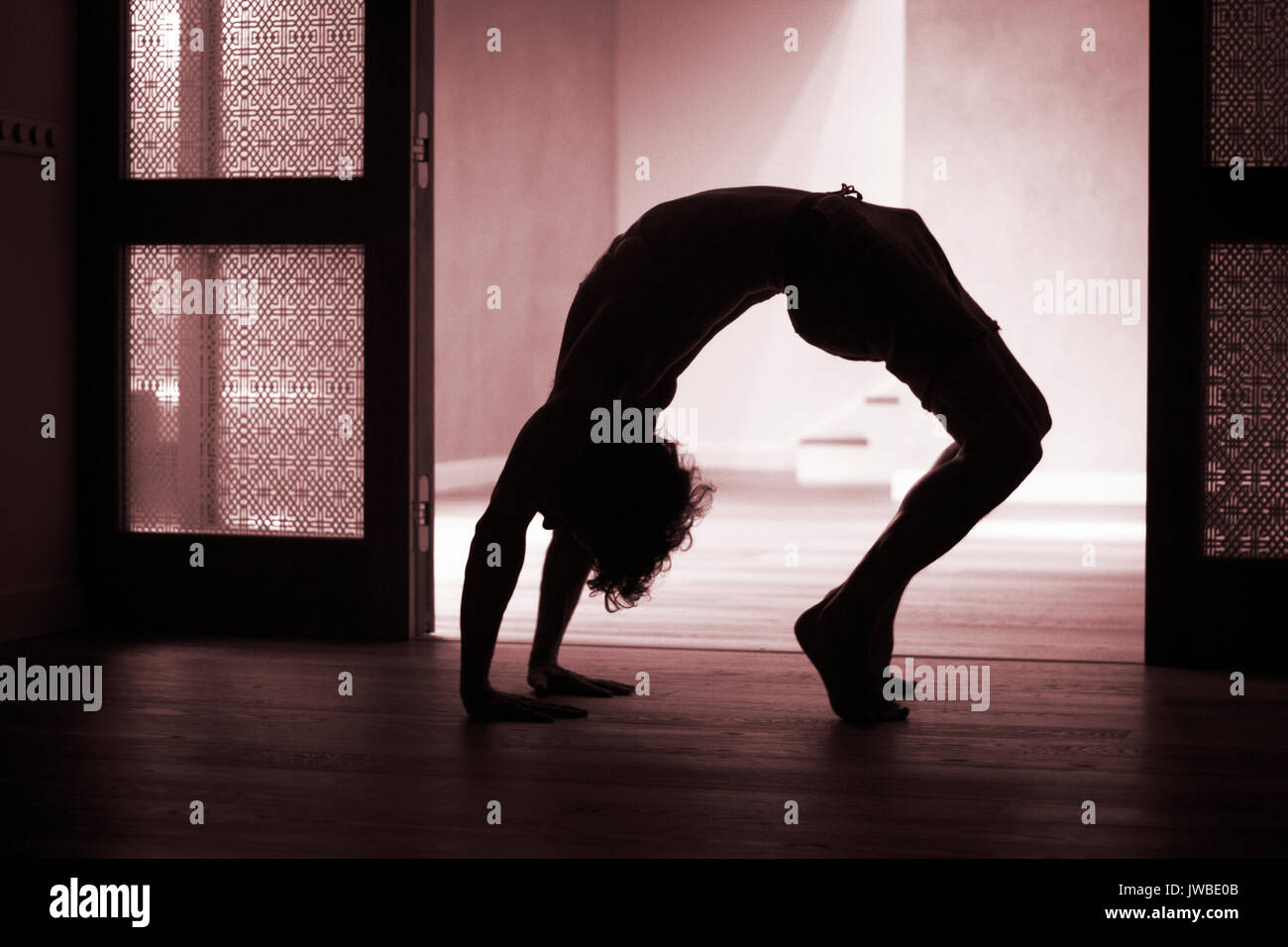 Yoga teacher doing backbend bridge flexibility and strength asana ...