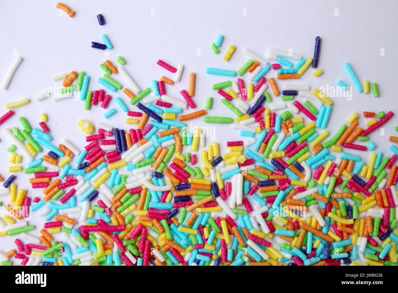 Colored sprinkles on white background Stock Photo Alamy