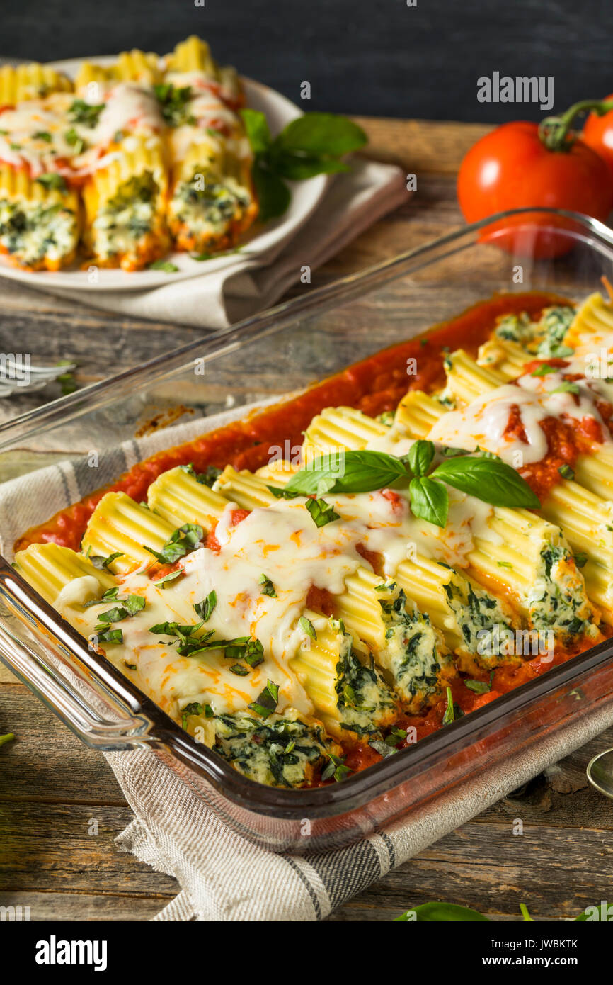 Homemade Stuffed Ricotta and Spinach Manicotti with Basil Stock Photo