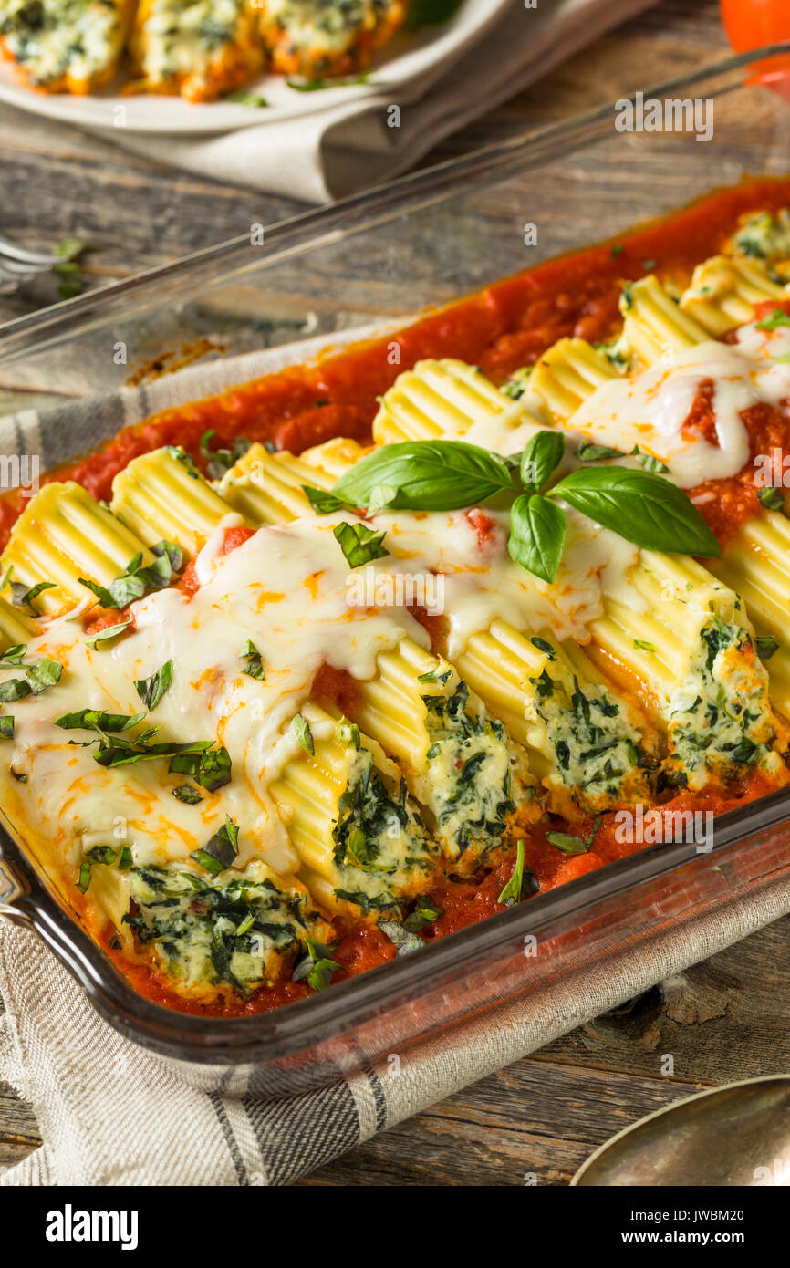 Homemade Stuffed Ricotta and Spinach Manicotti with Basil Stock Photo