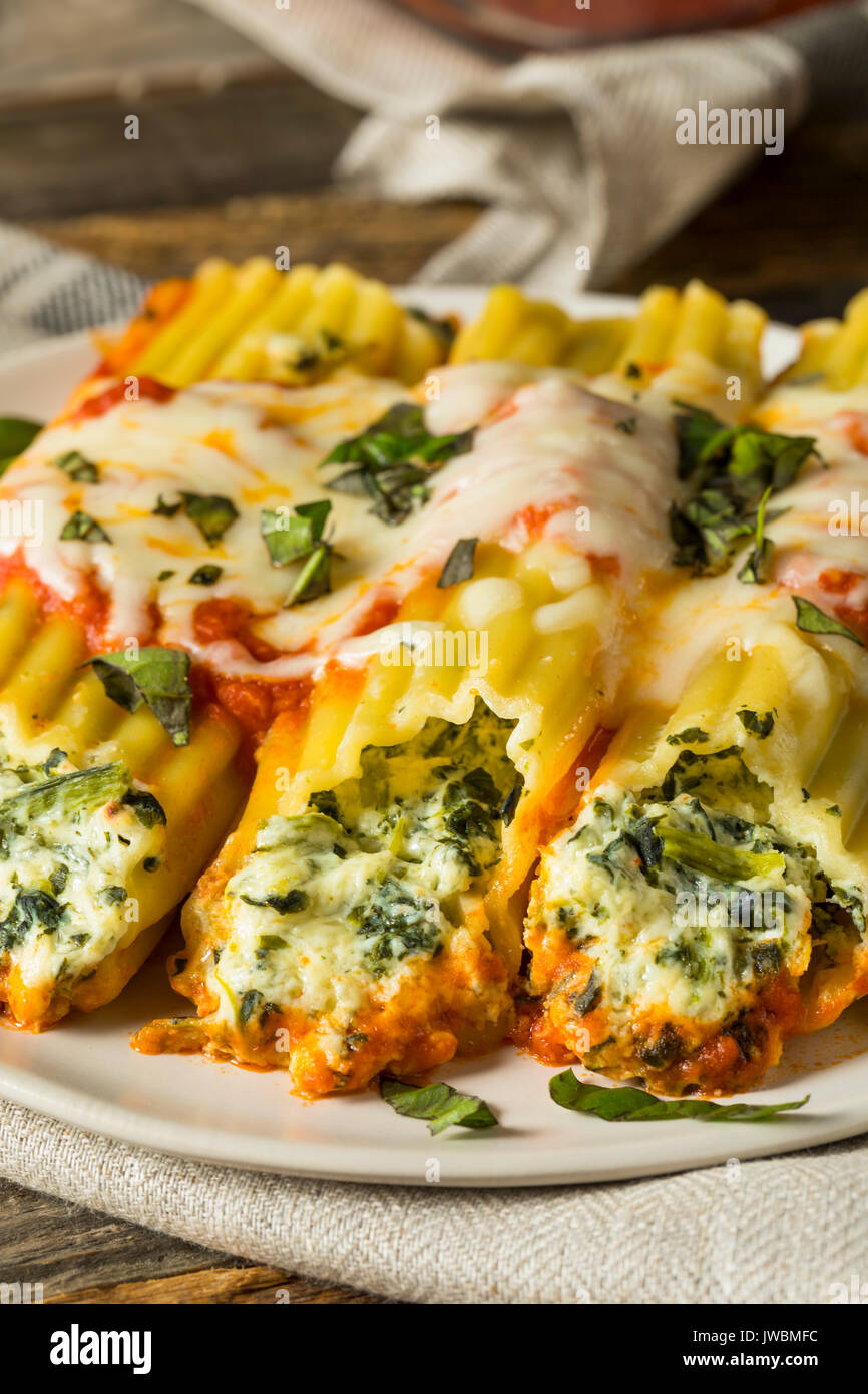 Homemade Stuffed Ricotta and Spinach Manicotti with Basil Stock Photo