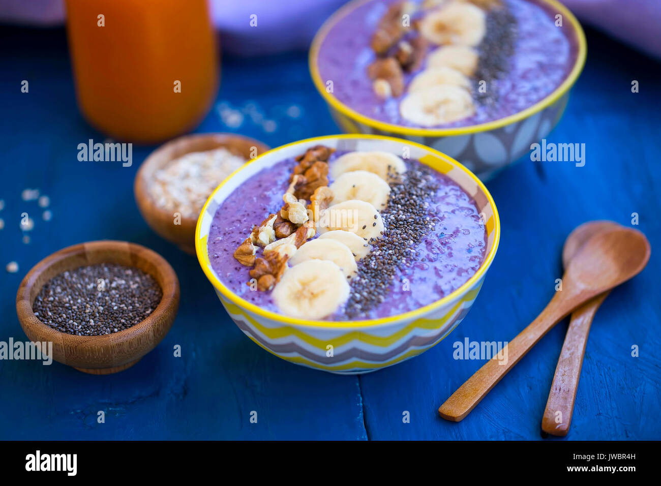 Smoothie bowls with blueberries, nuts , bananas and chia seeds, healthy vegan breakfast Stock Photo