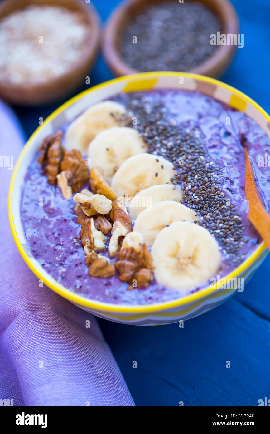 Smoothie bowl with blueberries, nuts , bananas and chia seeds, healthy vegan breakfast Stock Photo