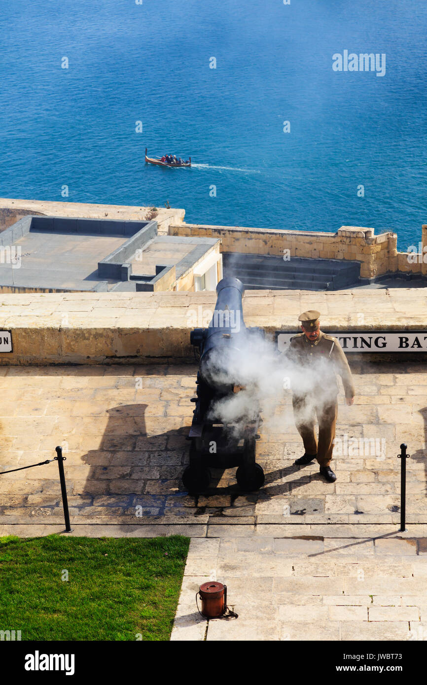 Firing the noon day gun over Grand Harbour from the Saluting Battery, Floriana, Valletta, Malta Stock Photo