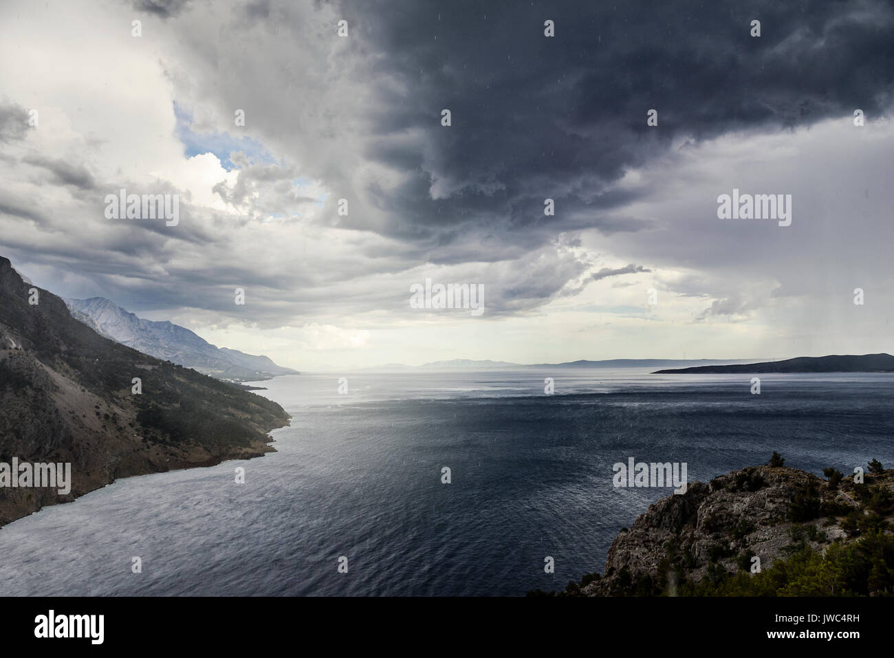 Dark stormy sky, sea waves, mountains Stock Photo - Alamy