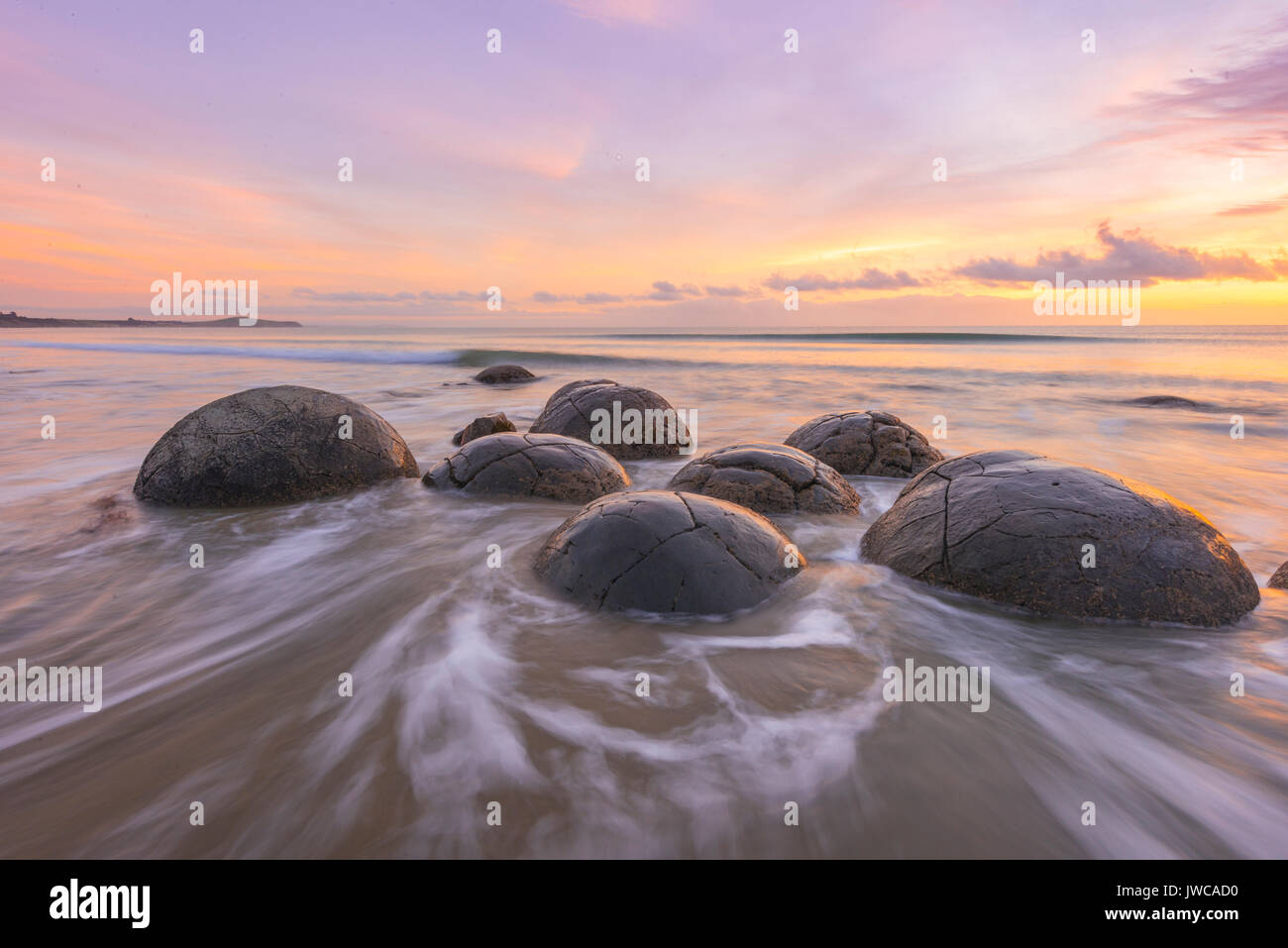 Moeraki boulders, at sunrise, geological formation, Koekohe Beach, Moeraki, East Coast, Otago, South Island, New Zealand Stock Photo