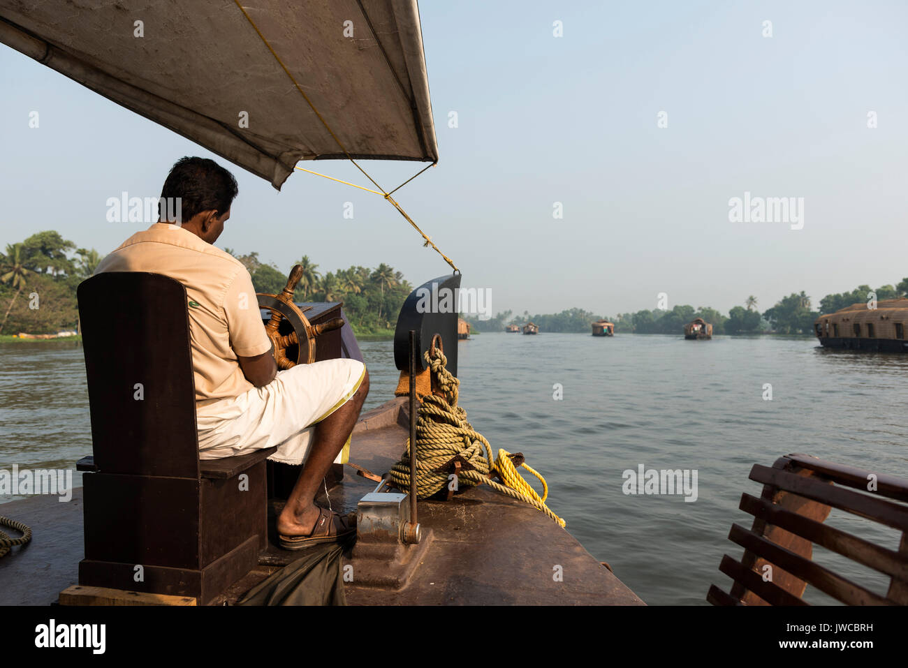 Boatman on kettuvallam, houseboat, Backwaters near Alappuzha, Malabar Coast, Kerala, India Stock Photo