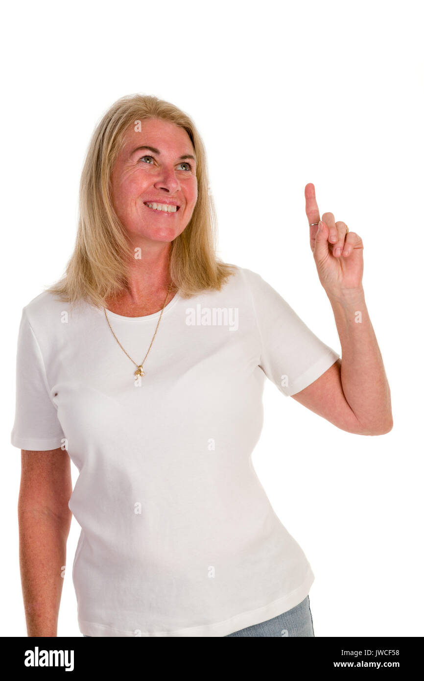cheerful middle-aged woman pointing up empty copyspace Stock Photo