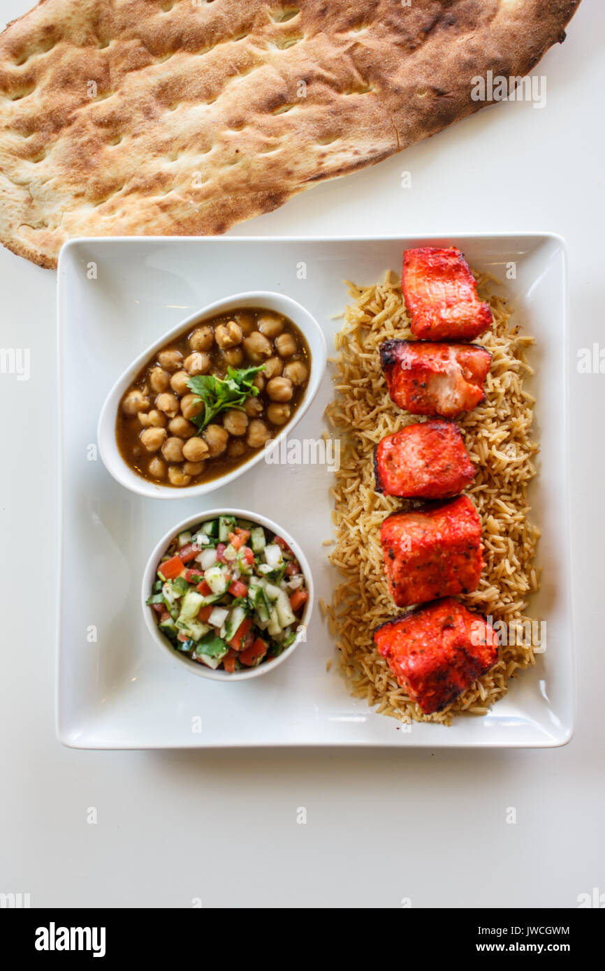chicken kabob dinner with rice, vegetables and naan Stock Photo Alamy