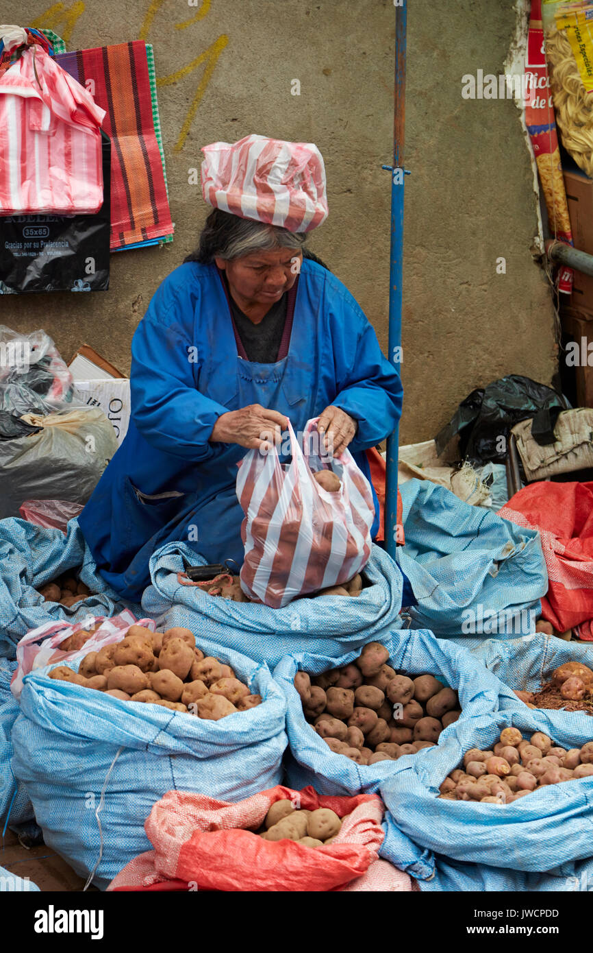 Cholita selling potatoes, El Alto, La Paz, Bolivia, South America Stock Photo