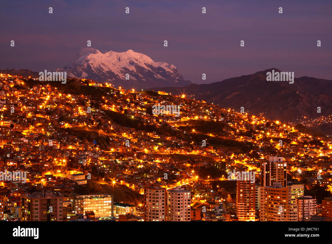 Last light on Illimani (6438m/21,122ft), and lights of La Paz, Bolivia, South America Stock Photo