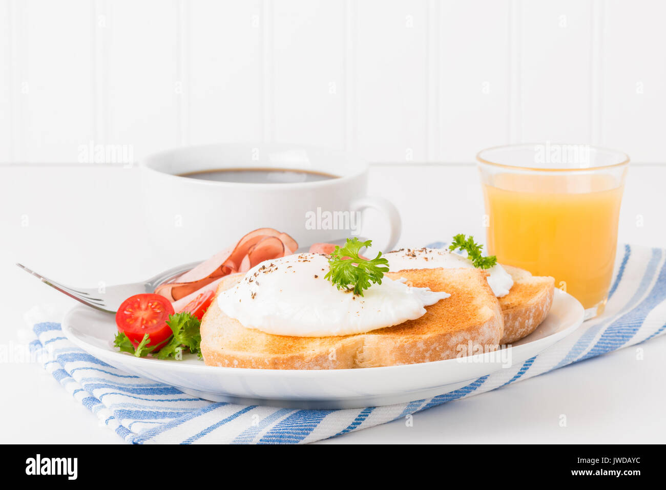 Perfectly poached eggs on toast with ham Stock Photo - Alamy