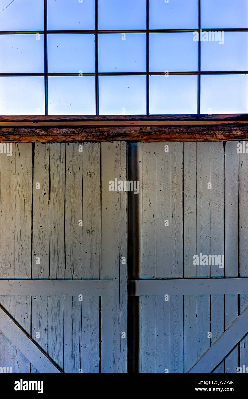 Looking through old rustic window of house with ocean view in ...