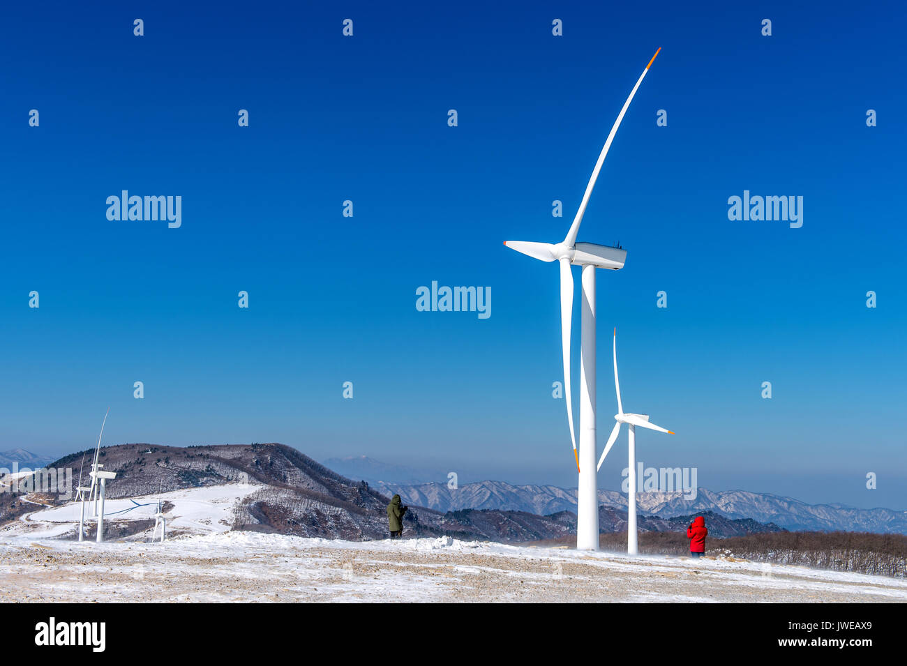 Wind turbine and blue sky in winter landscape Stock Photo - Alamy