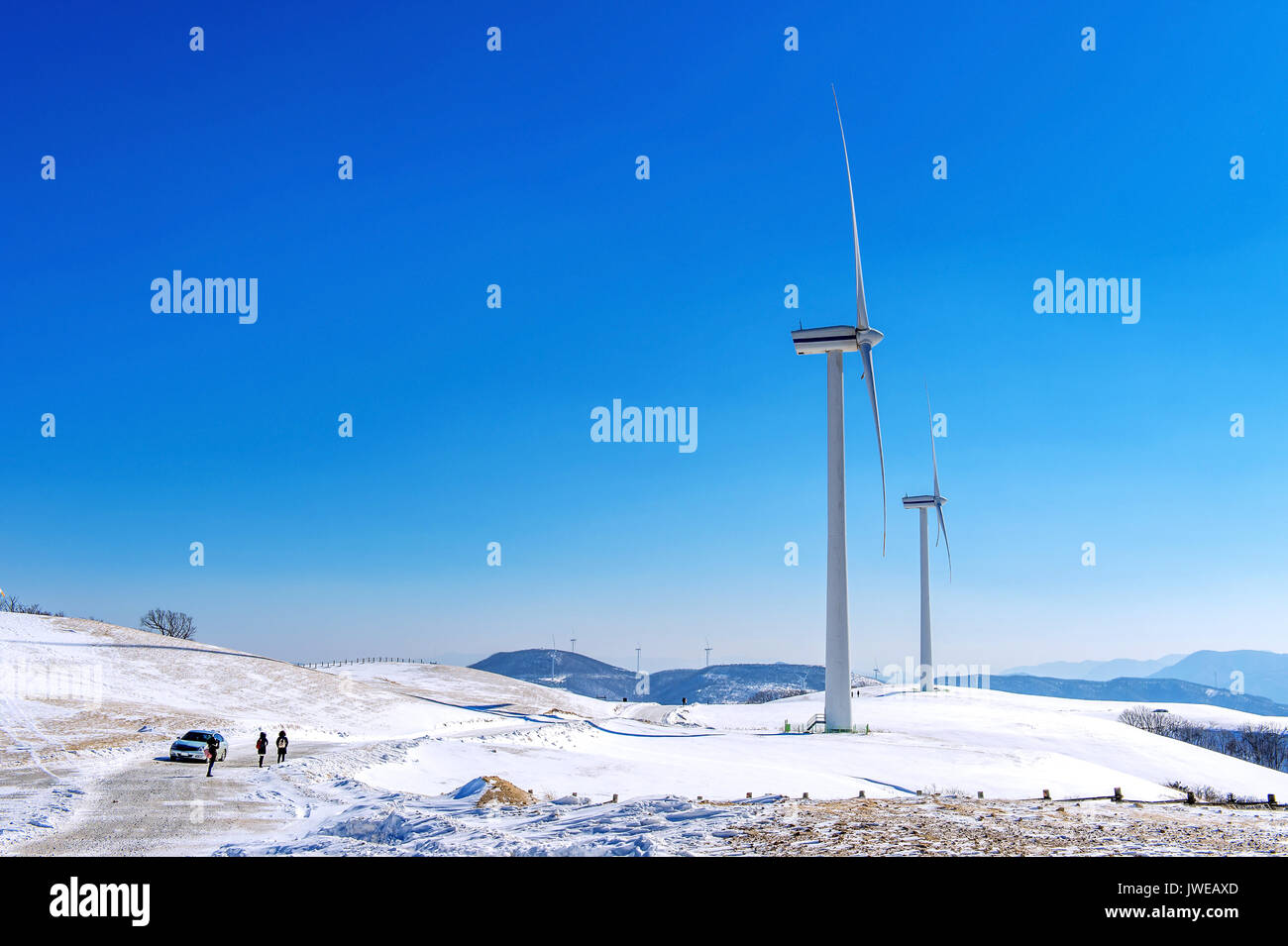Wind turbine and blue sky in winter landscape Stock Photo - Alamy