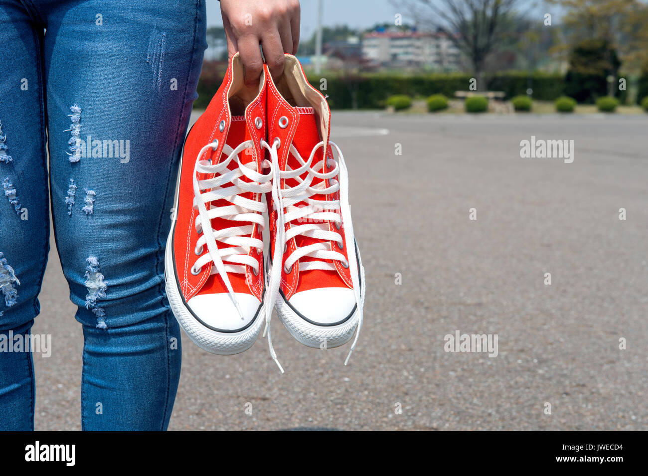 woman hand holding a red sneakers with space for text or symbol. Stock Photo