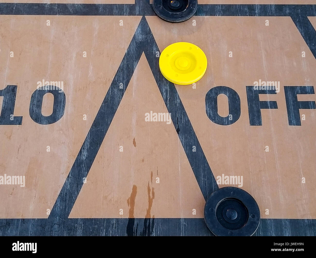 black and yellow shuffleboard discs on court Stock Photo Alamy