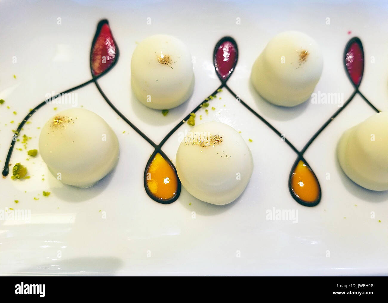 white chocolate truffle candy with gold glitter and elegant design on plate  Stock Photo - Alamy
