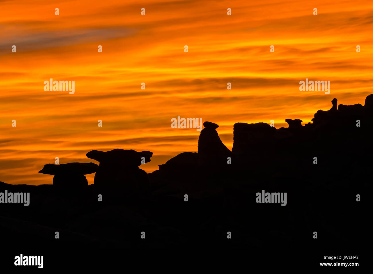 Glowing sunset over the Bisti/De-Na-Zin Wilderness near Farmington, New Mexico, USA Stock Photo