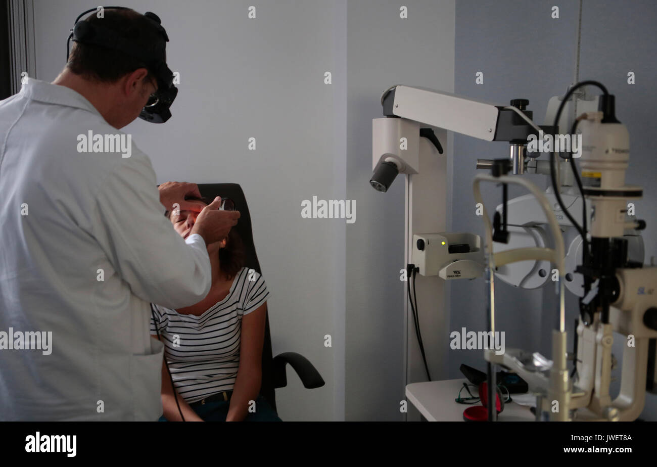doctor checking patient vision at optical clinic Stock Photo Alamy
