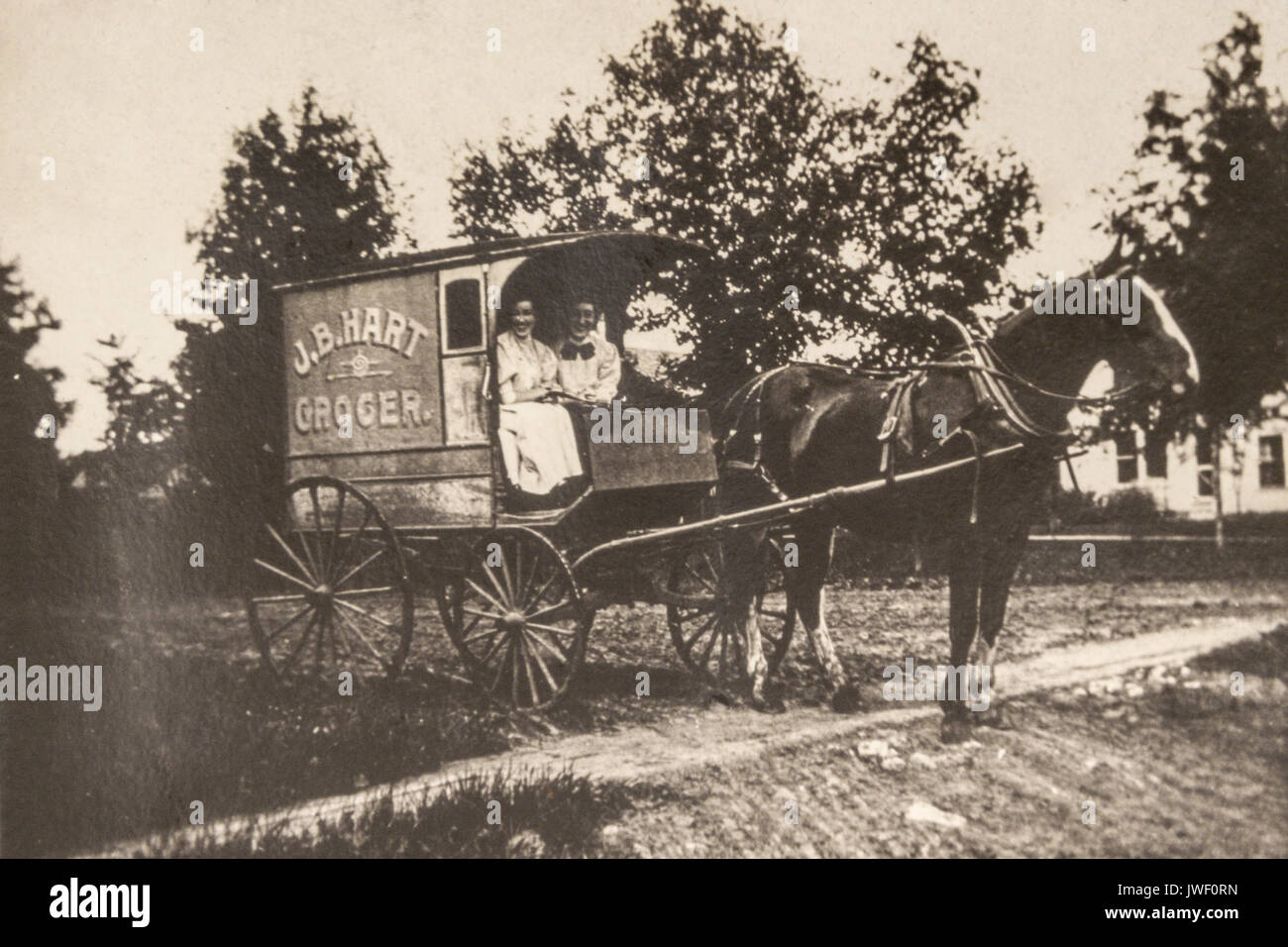 Two Women in a JB Hart Grocer delivery wagon in Minnesota USA 1907-1908 and having fun Stock Photo