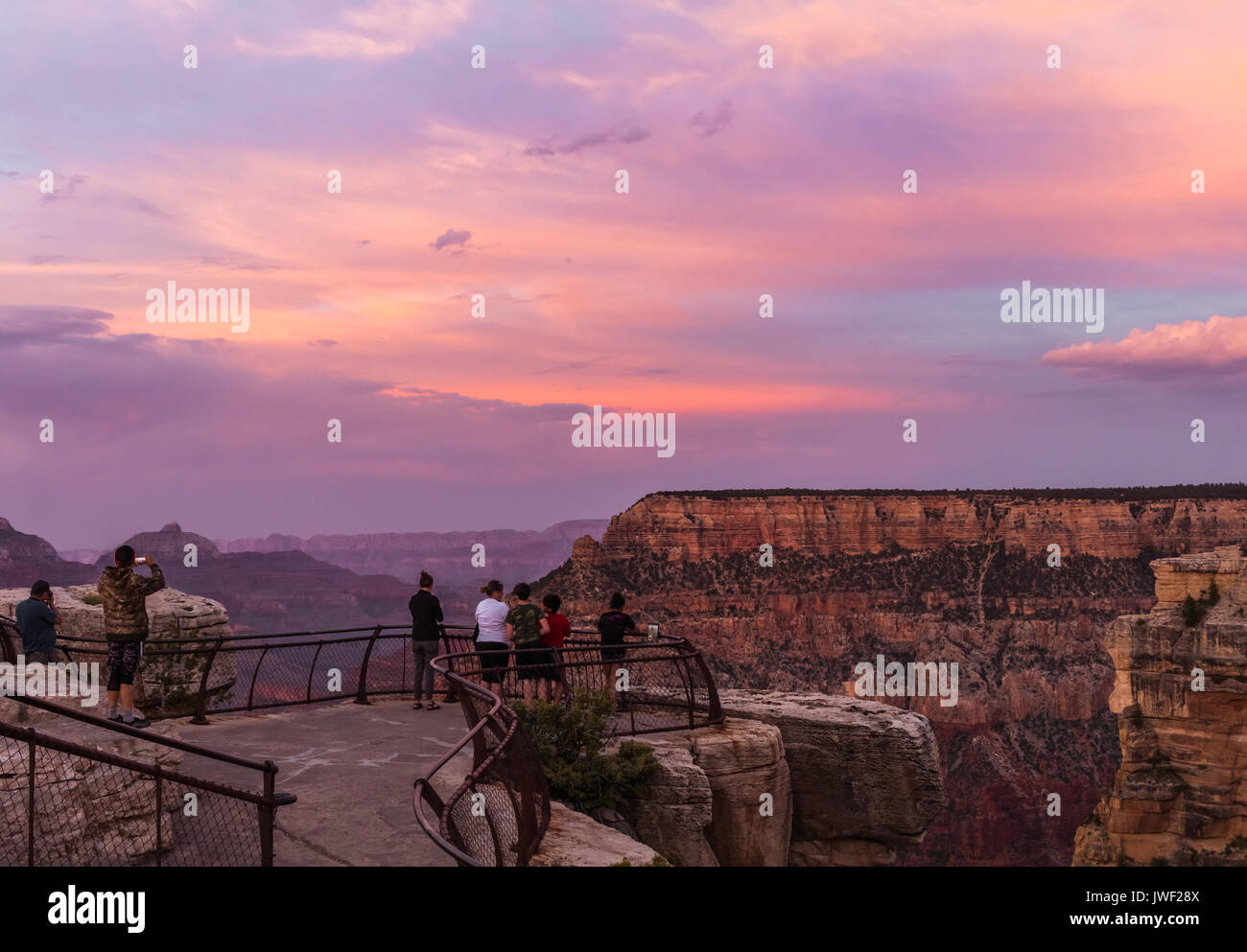 Colorful sunset in the Grand Canyon, Arizona; people are taking photos of the sunset Stock Photo