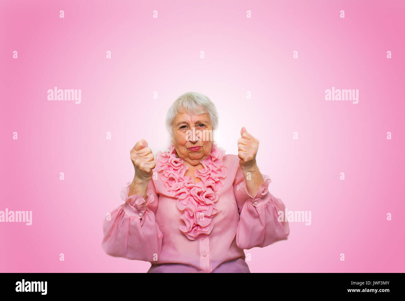 Elderly woman in suspense and determination Stock Photo