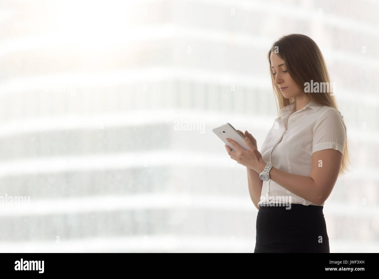 Confident successful businesswoman holding using digital tablet  Stock Photo