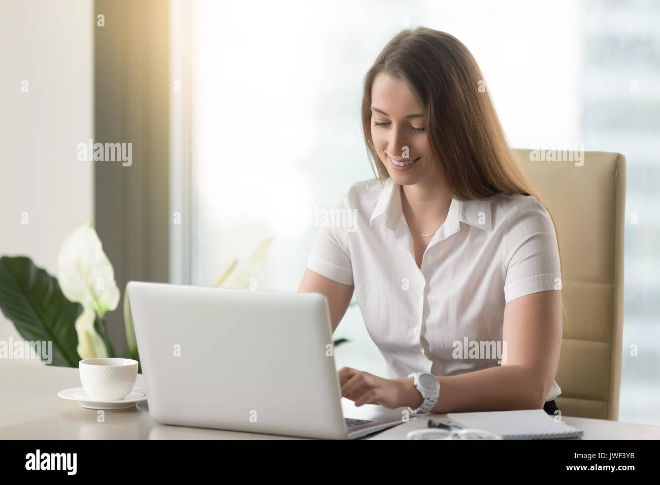 Smiling businesswoman using laptop, happy employee communicating Stock ...