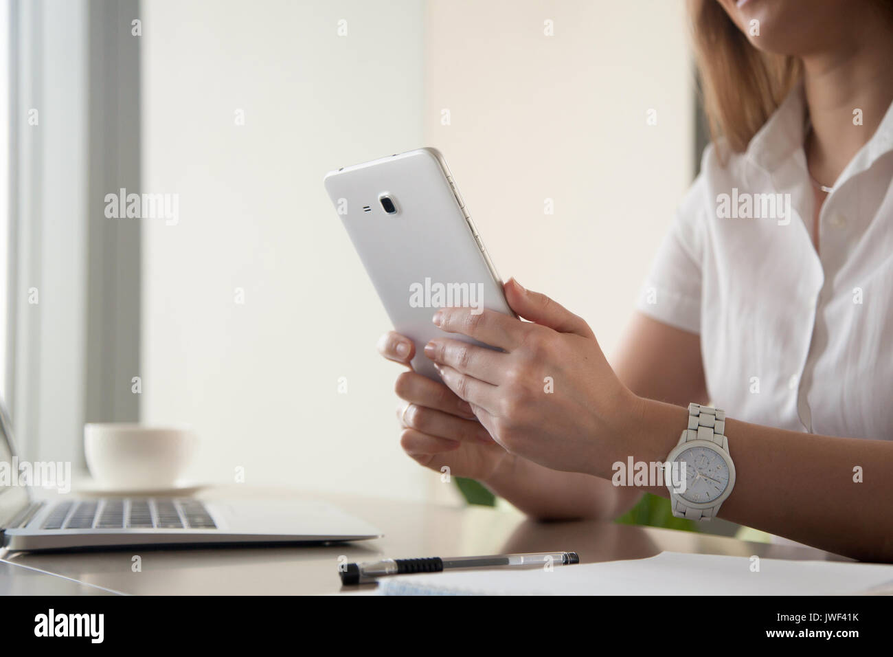 Female hands holding digital tablet at work desk, close up Stock Photo ...
