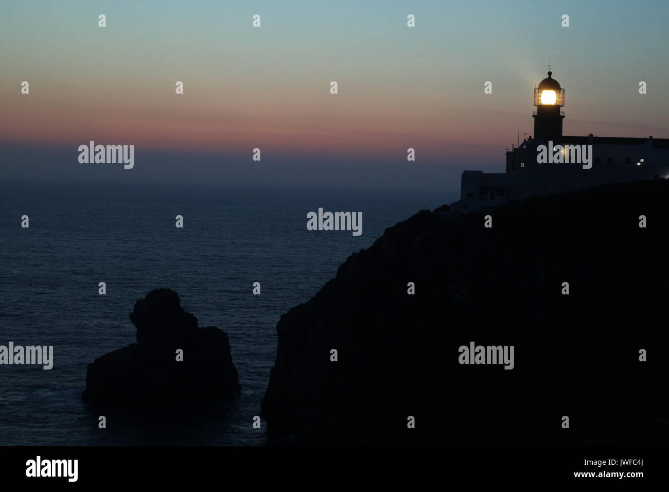 The Lighthouse of Cabo de Sao Vicente is beacon/lighthouse located along the coastal peninsula of Sagres Point in Algarve, Portugal. Stock Photo