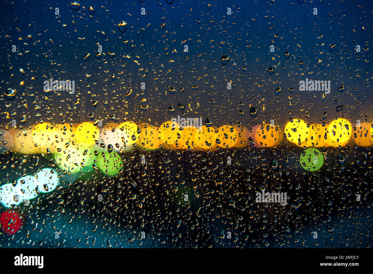 raindrops on window with bokeh of light Stock Photo - Alamy
