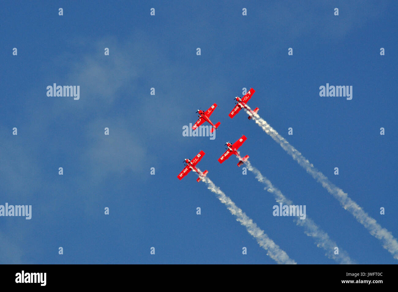 Red airplanes on the blue sky backgorund during airshow in Gdynia ...