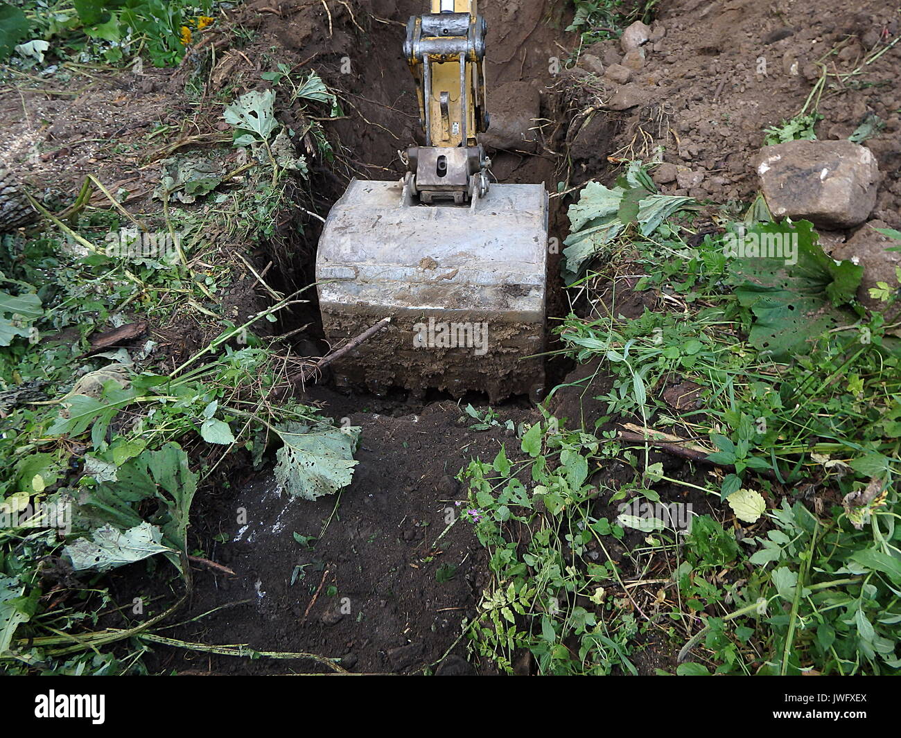 Excavator digging a deep trench, Bucket digger Stock Photo Alamy