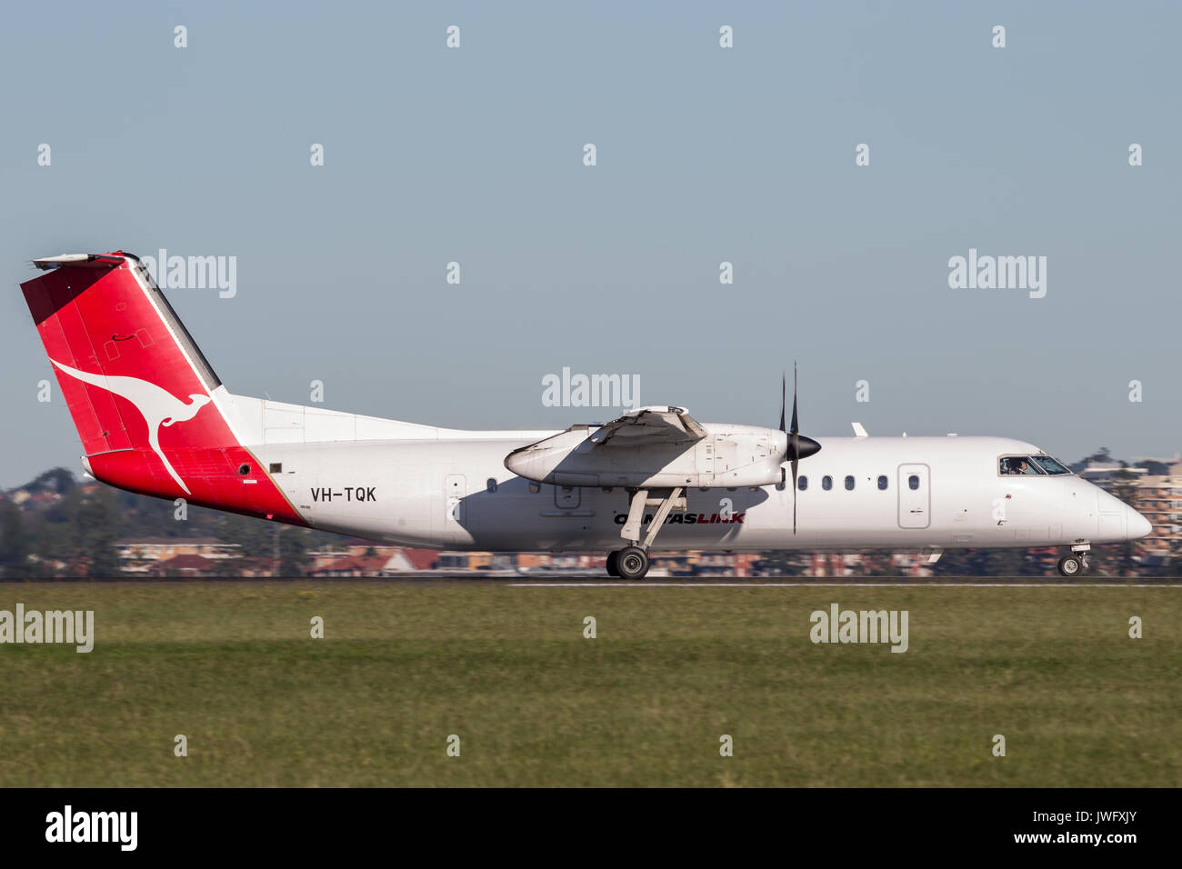 QantasLink deHavilland DHC-8 (Dash 8) twin engined regional airliner at Sydney Airport. Stock Photo