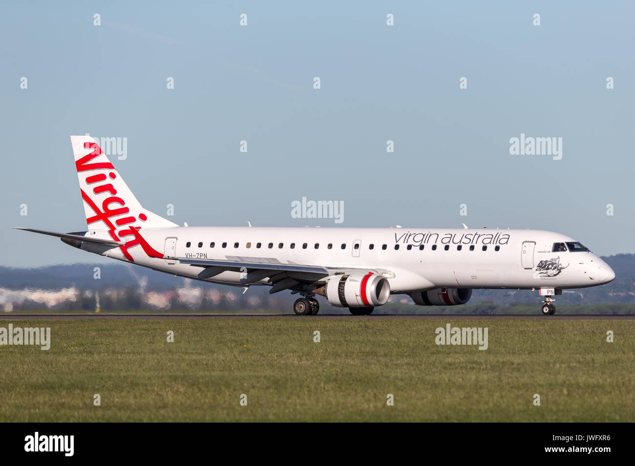 Virgin Australia Embraer regional jet (ERJ-190) landing at Sydney Airport. Stock Photo