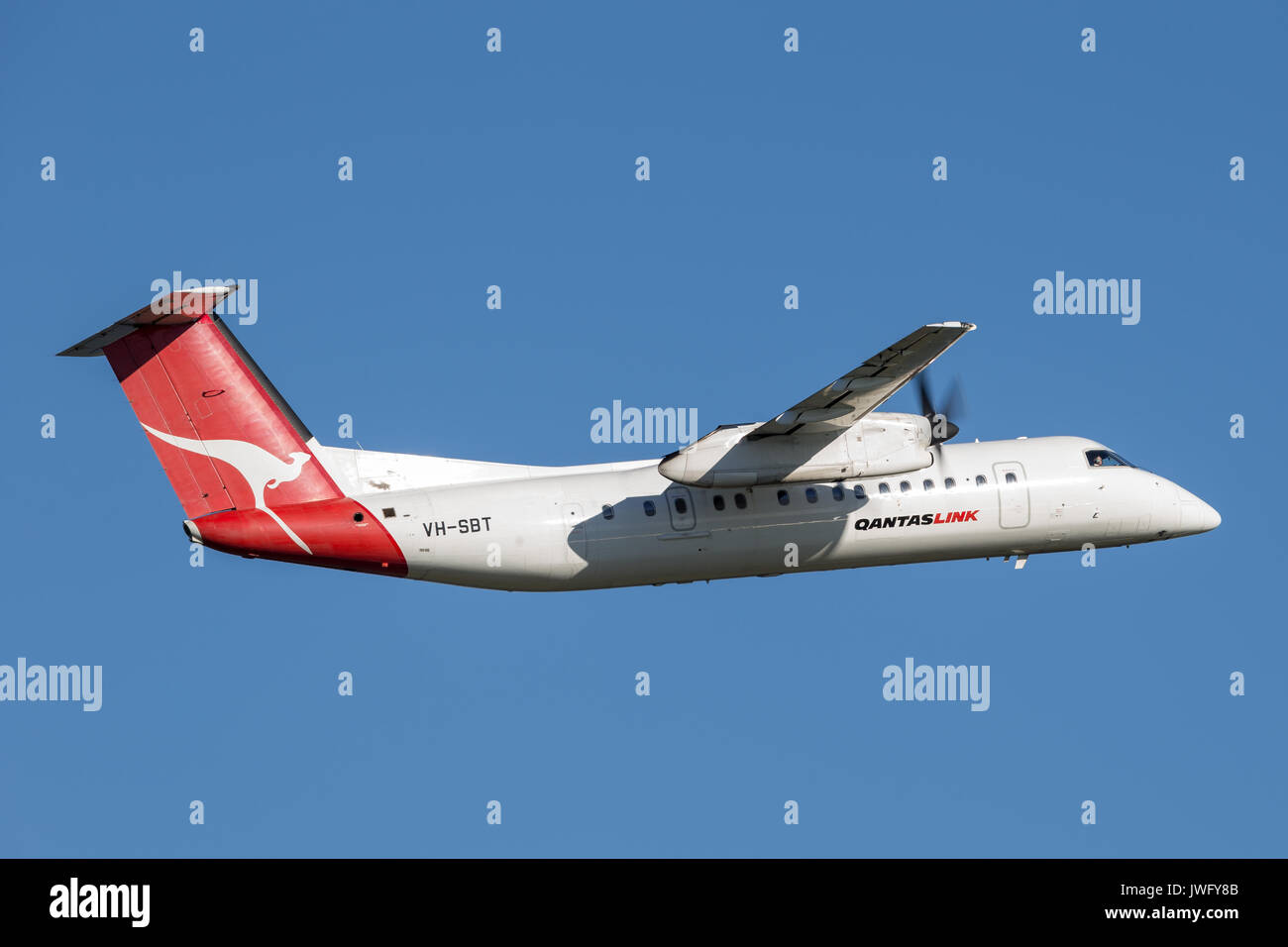 QantasLink (Qantas) deHavilland DHC-8 (Dash 8) twin engined regional airliner aircraft departing Sydney Airport. Stock Photo