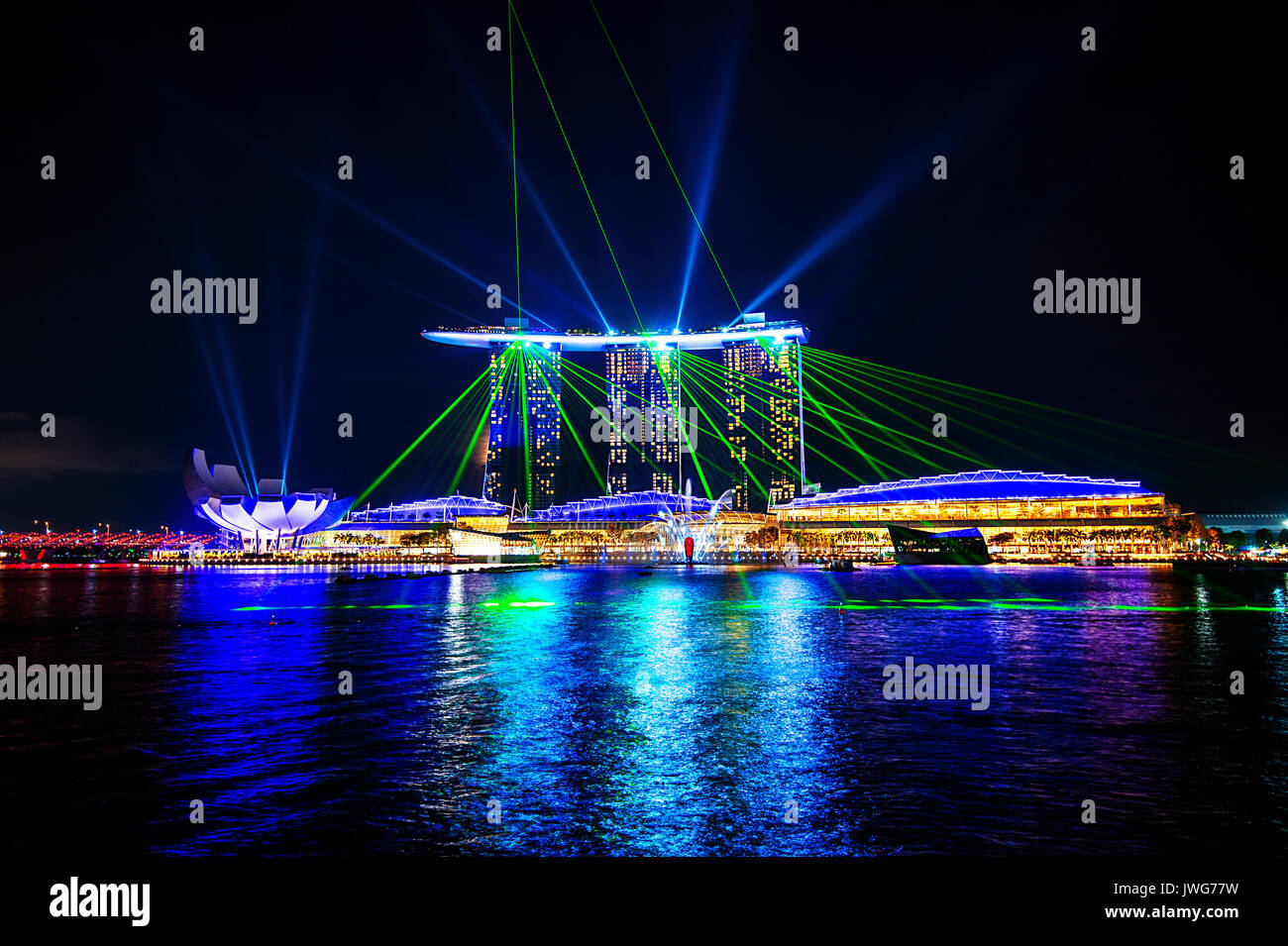 Singapore city at night with laser show. Stock Photo