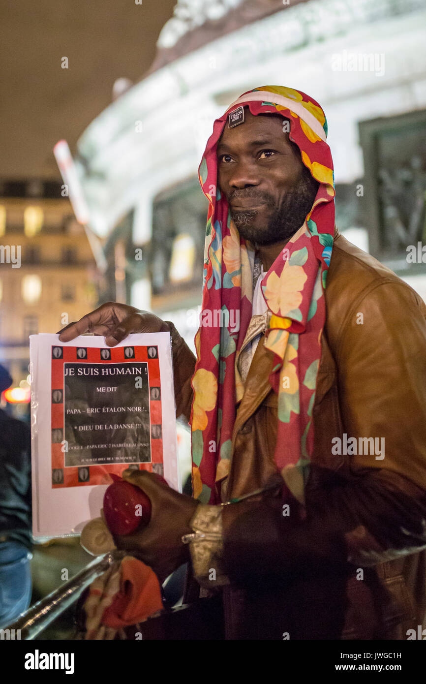 a black man with a sign i am human. Homage at the victims of Charlie hebdo killing in Paris the 7th of january 2015. Stock Photo