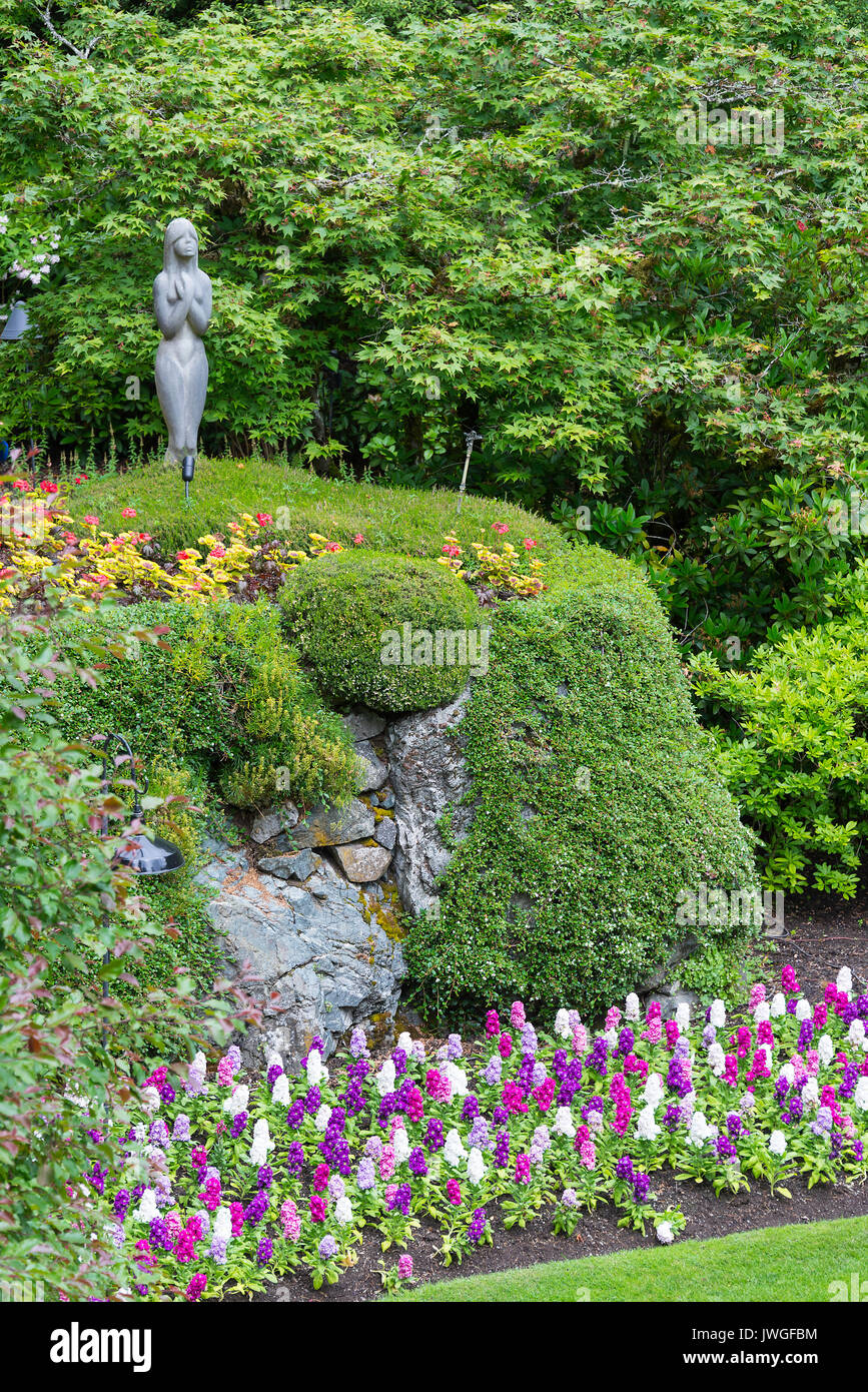 The Beautiful Sunken Garden with a Colourful Display of Bedding Out Plants, Shrubbery Rock Features and Trees at Butchart Gardens Victoria BC Canada Stock Photo