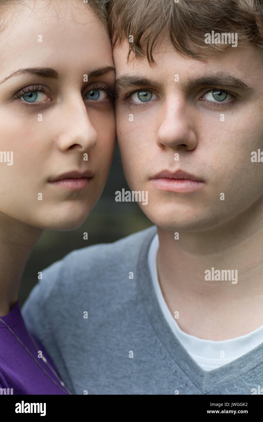 Close up of a young coupole faces with blue eyes staring outdoors Stock Photo