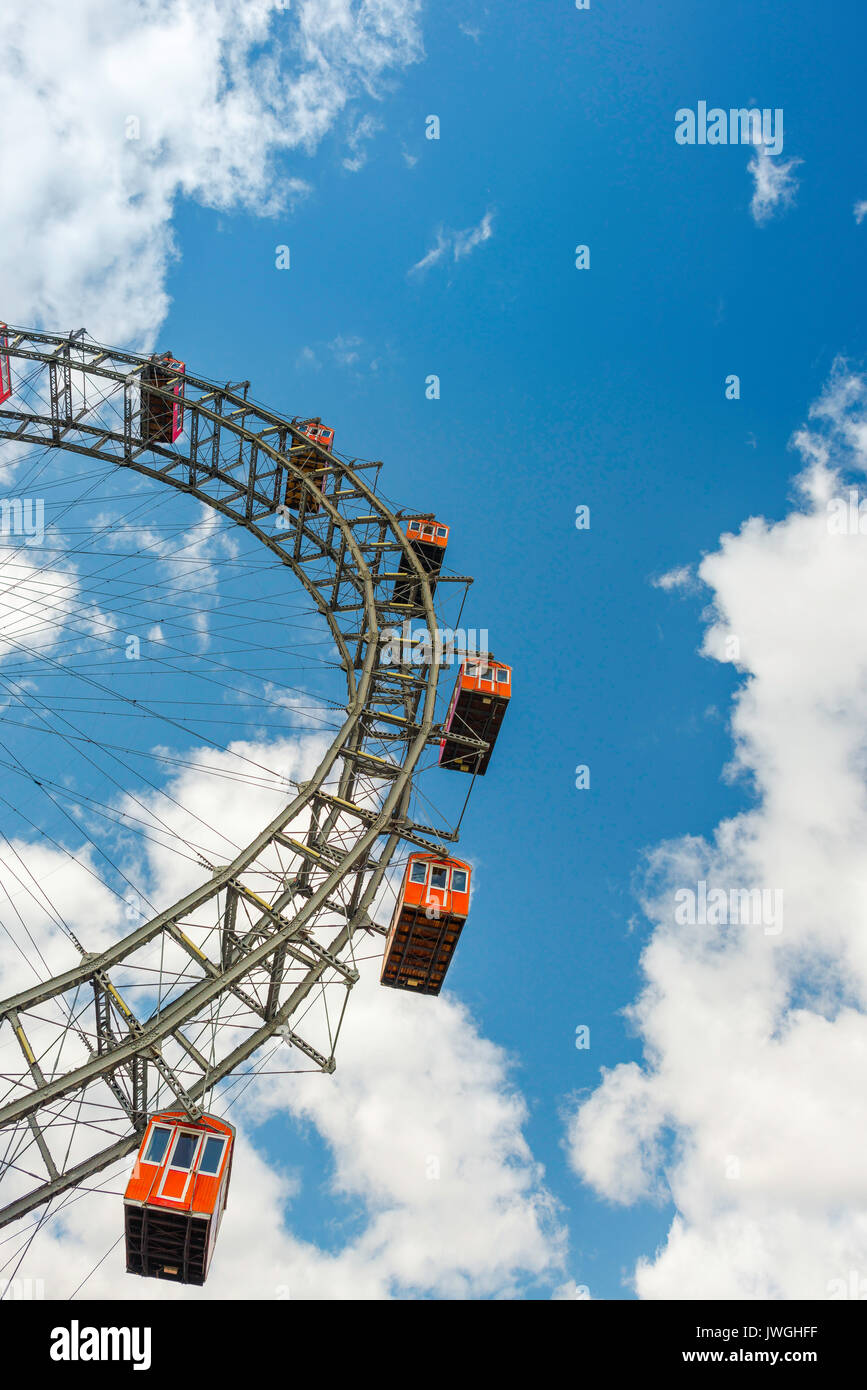 Vienna ferris wheel, view against sky and clouds of a section of the famous Riesenrad ferris wheel in the Prater amusement park in Vienna, Austria. Stock Photo
