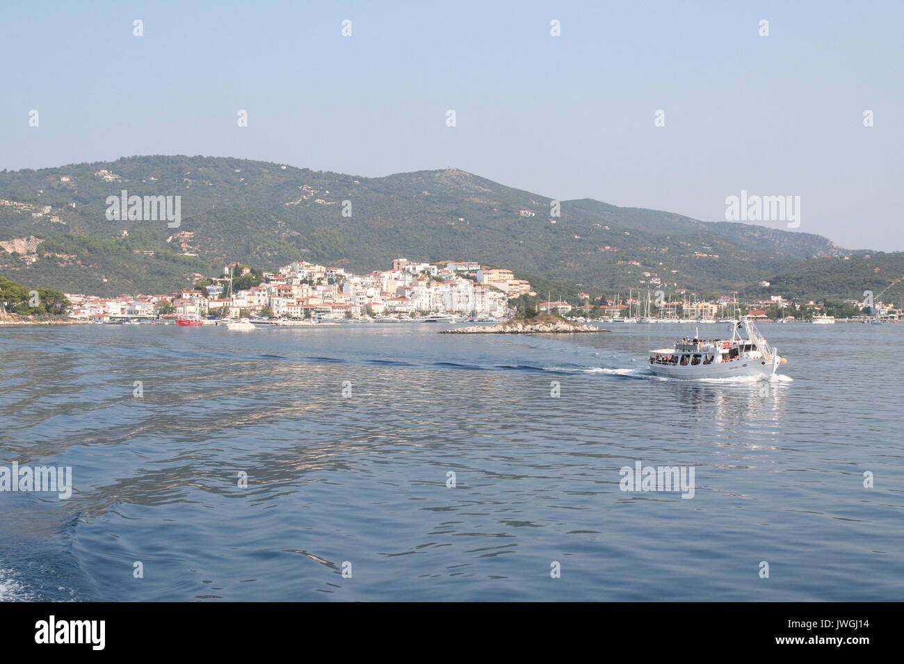 Boat of tourists leaves Skiathos for a day trip. Stock Photo