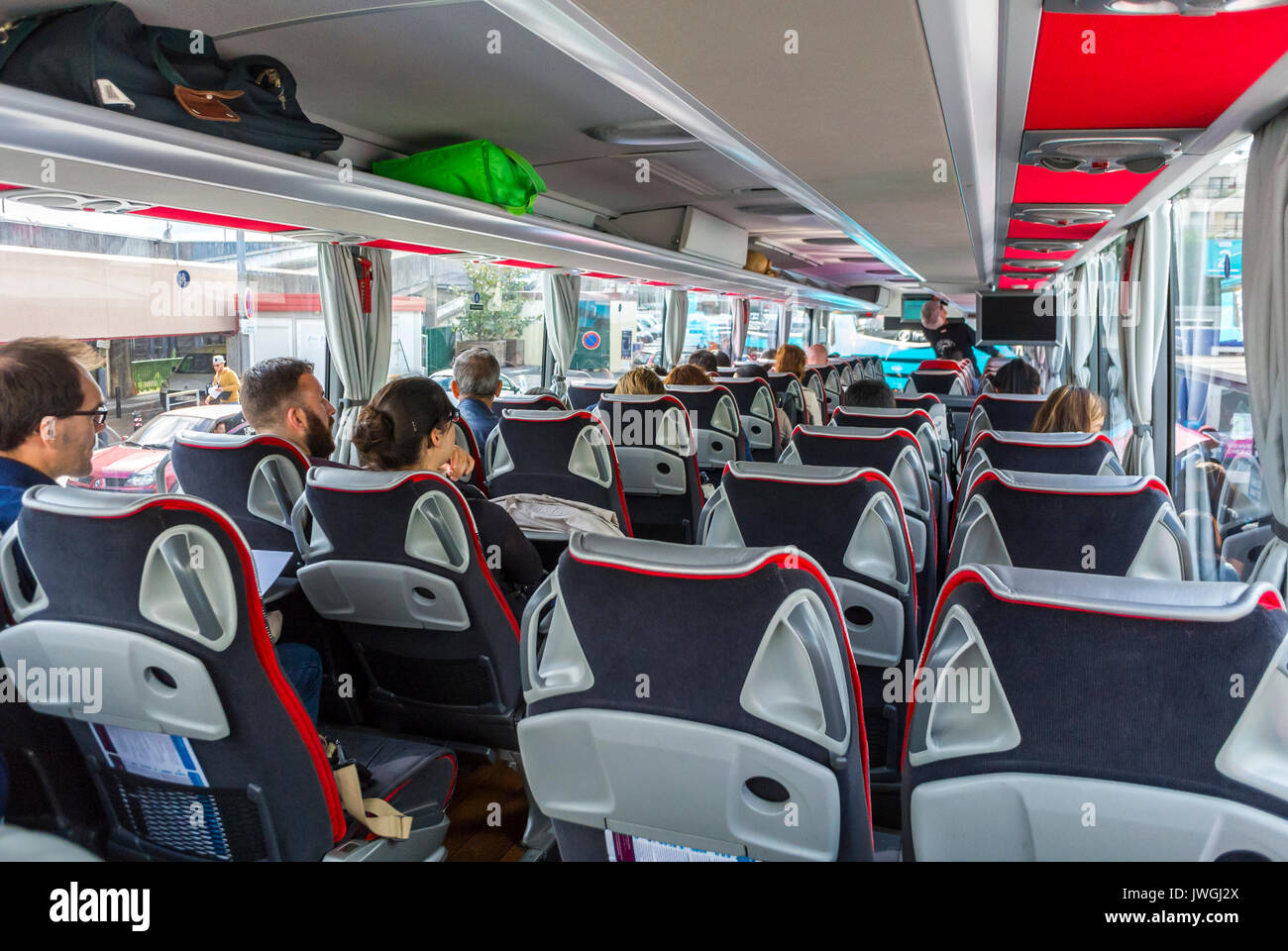 Paris, France, teens Tourists sitting on Low Cost DIscount Bus, Ouibus, contemporary interiors Stock Photo