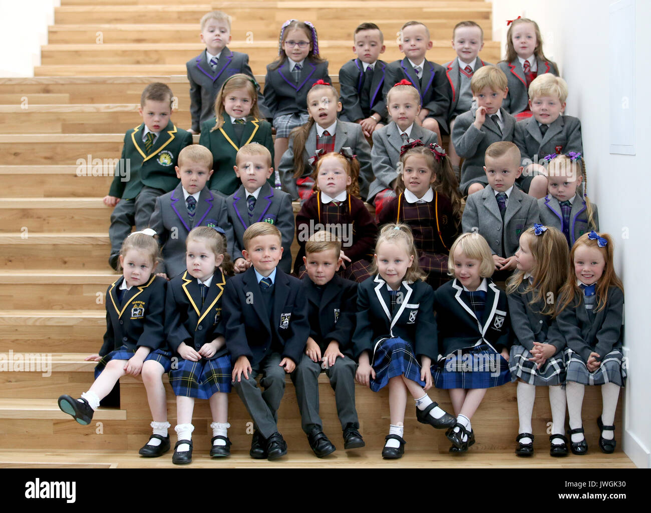 13 sets of twins, (from top left) Lucas and Peyton Anderson, Cameron and Christopher Collins, Cooper and Cora Deegan, (second row) Billy and Louise Dominick, Annie and Penny Donnelly, Cameron and Craig Hynes, (third row) Tyler and Zach McAllister, Kendal and Skye McCabe, Leighton and Marcie McDevitt, (bottom row) Elanor and Isobel McShane, Harry and Reilly Small, Martine and Naomi Smith and Hannah and Mealla Wright, who are starting primary school in the Inverclyde area this week gathered together for a photocall at St Patrick's Primary School in Greenock. Stock Photo