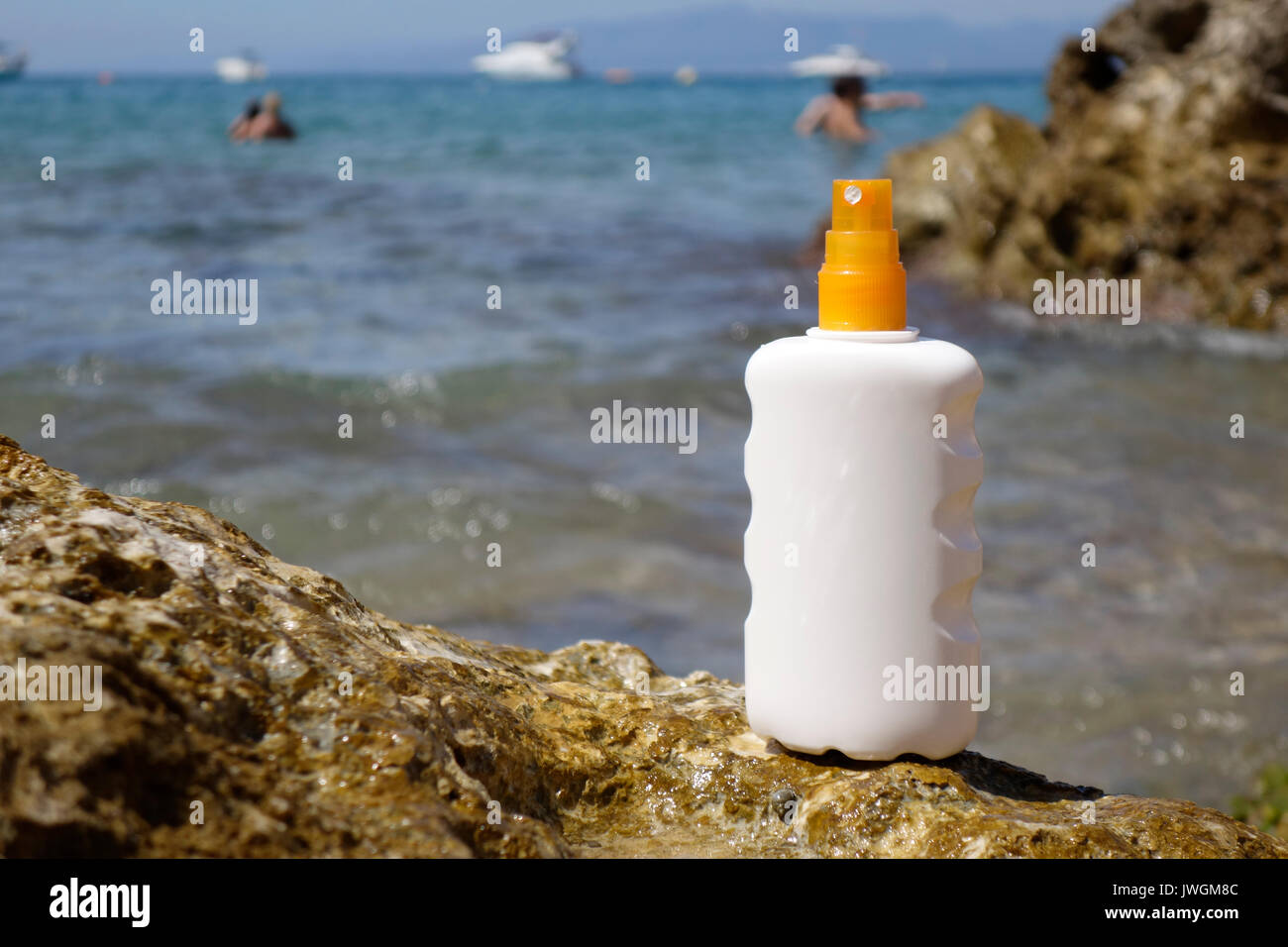 Sun cream bottle in front of the sea, in the beach Stock Photo